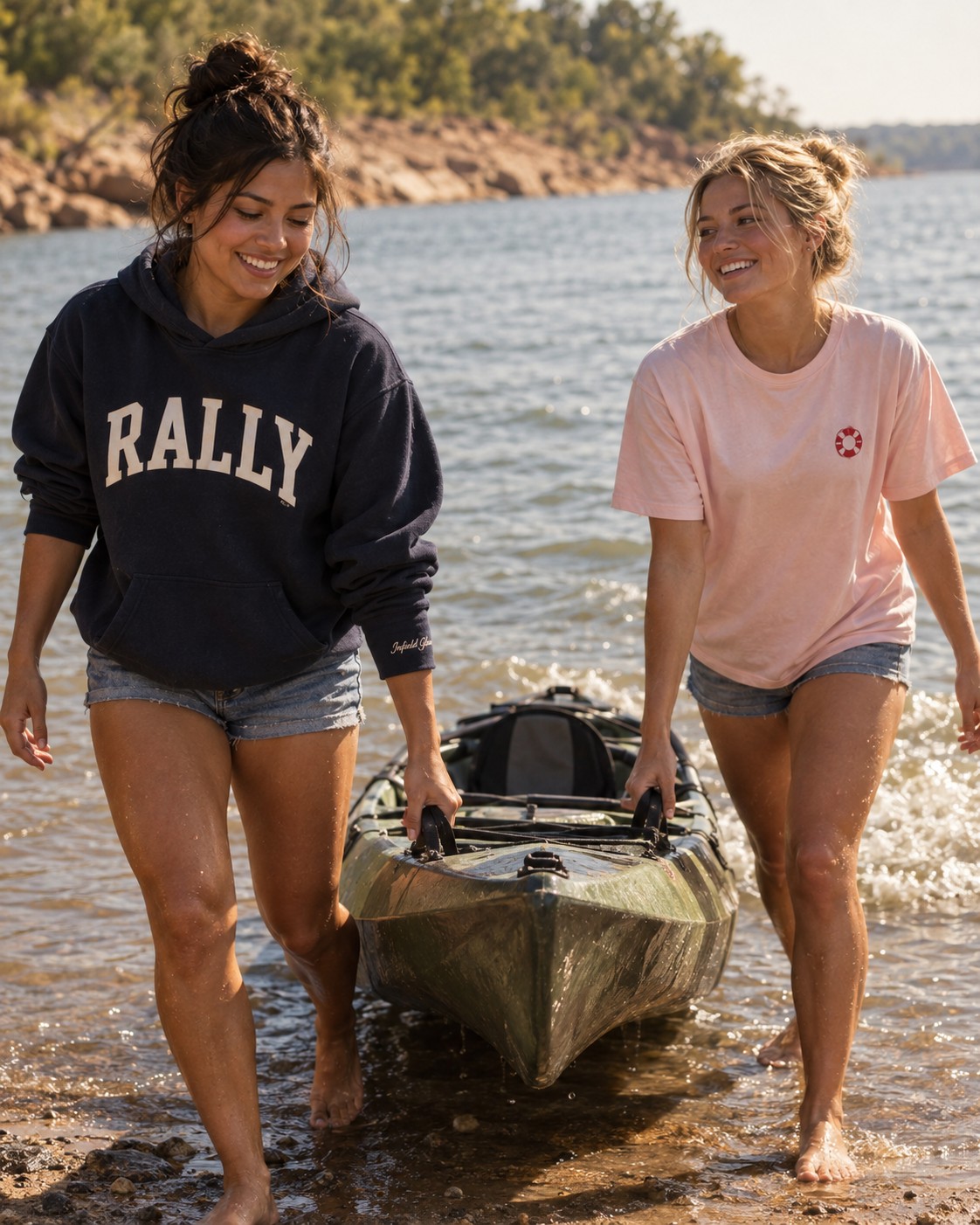 two friends pulling a kayak up onto a lake shore, wet hands and bare feet, warm midday light