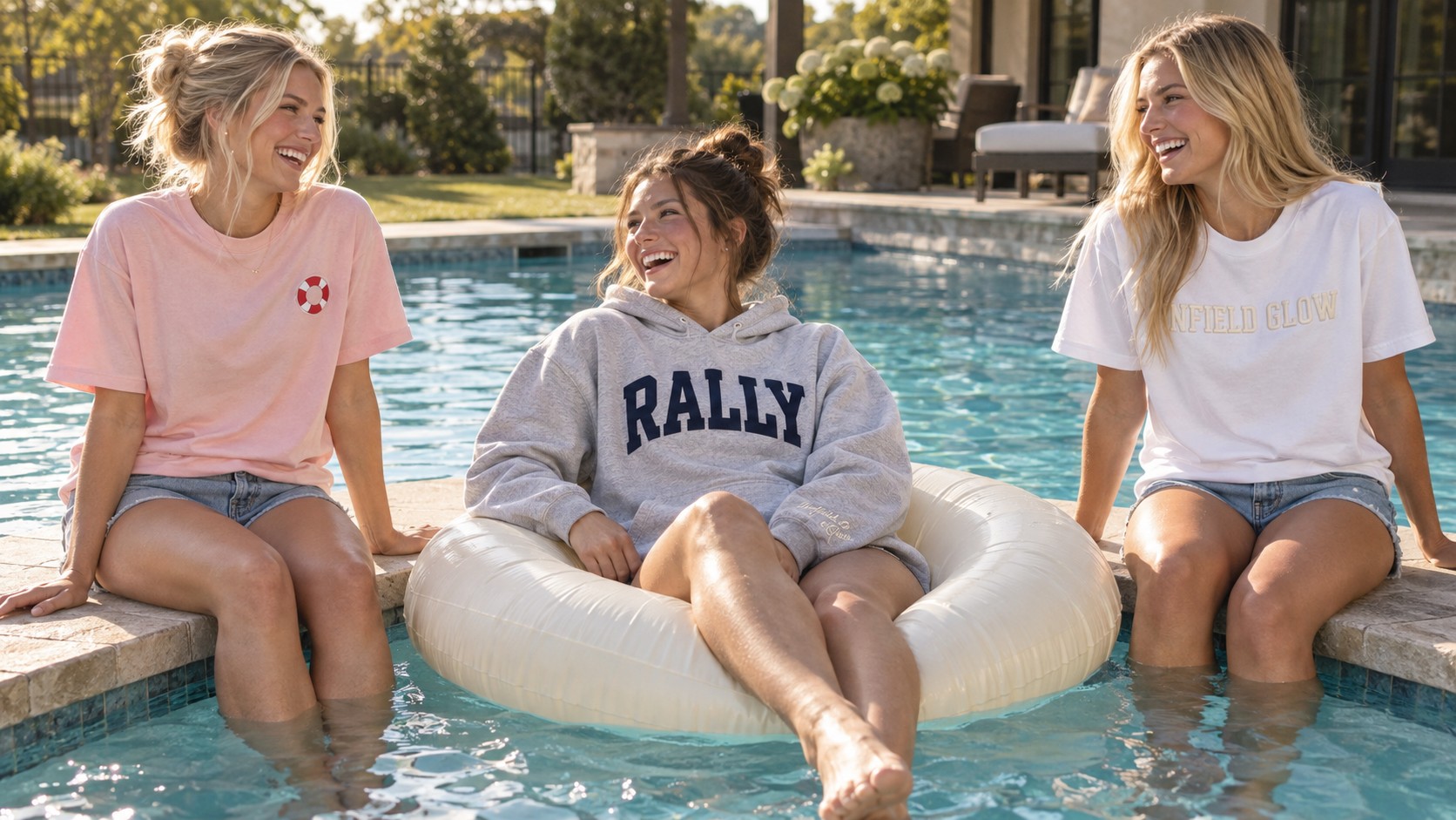 three friends around a pool, one on an inflatable float and two sitting on the edge, bright summer afternoon