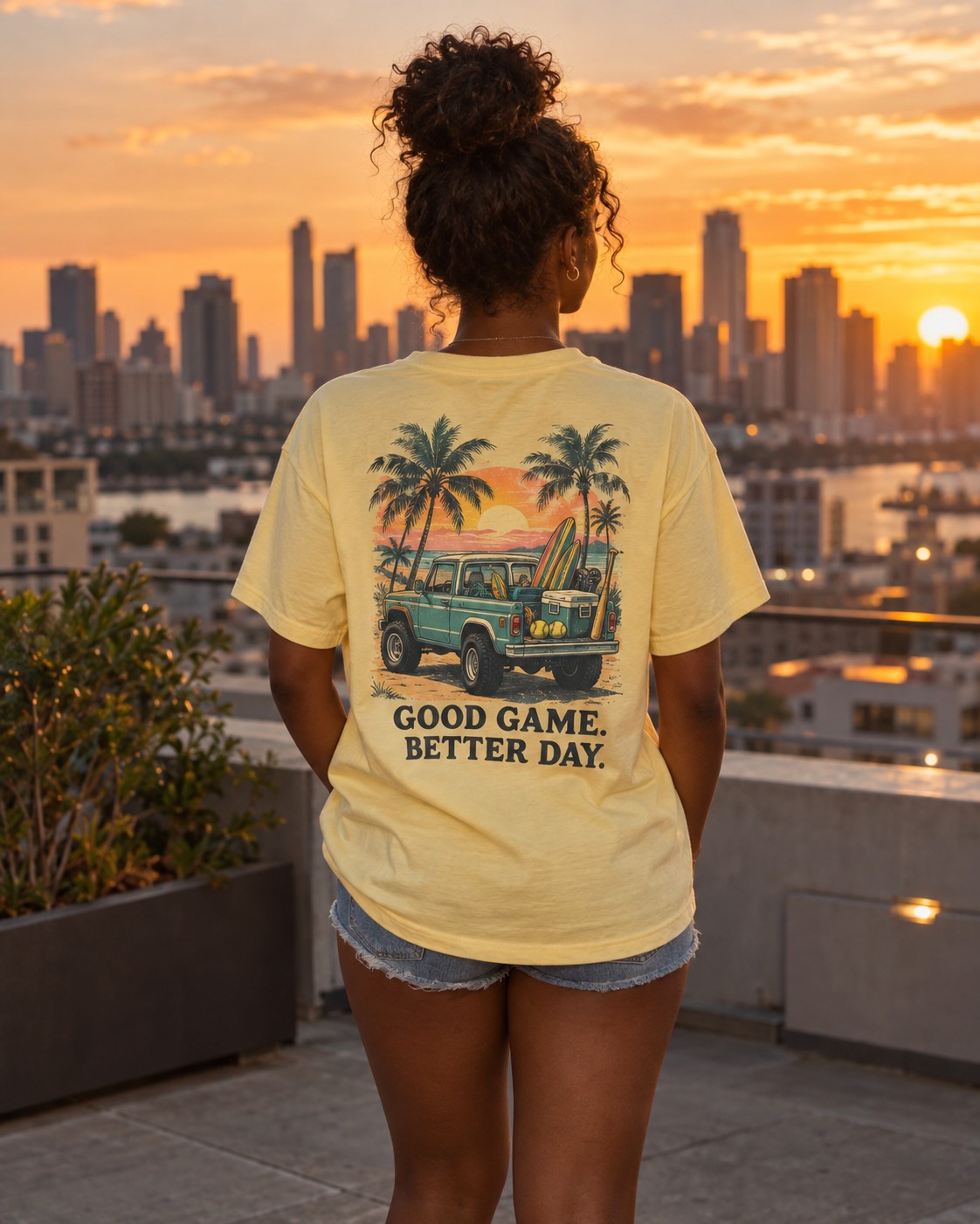 a girl on a city rooftop at sunset looking out over the skyline, seen from behind so the back graphic reads clearly